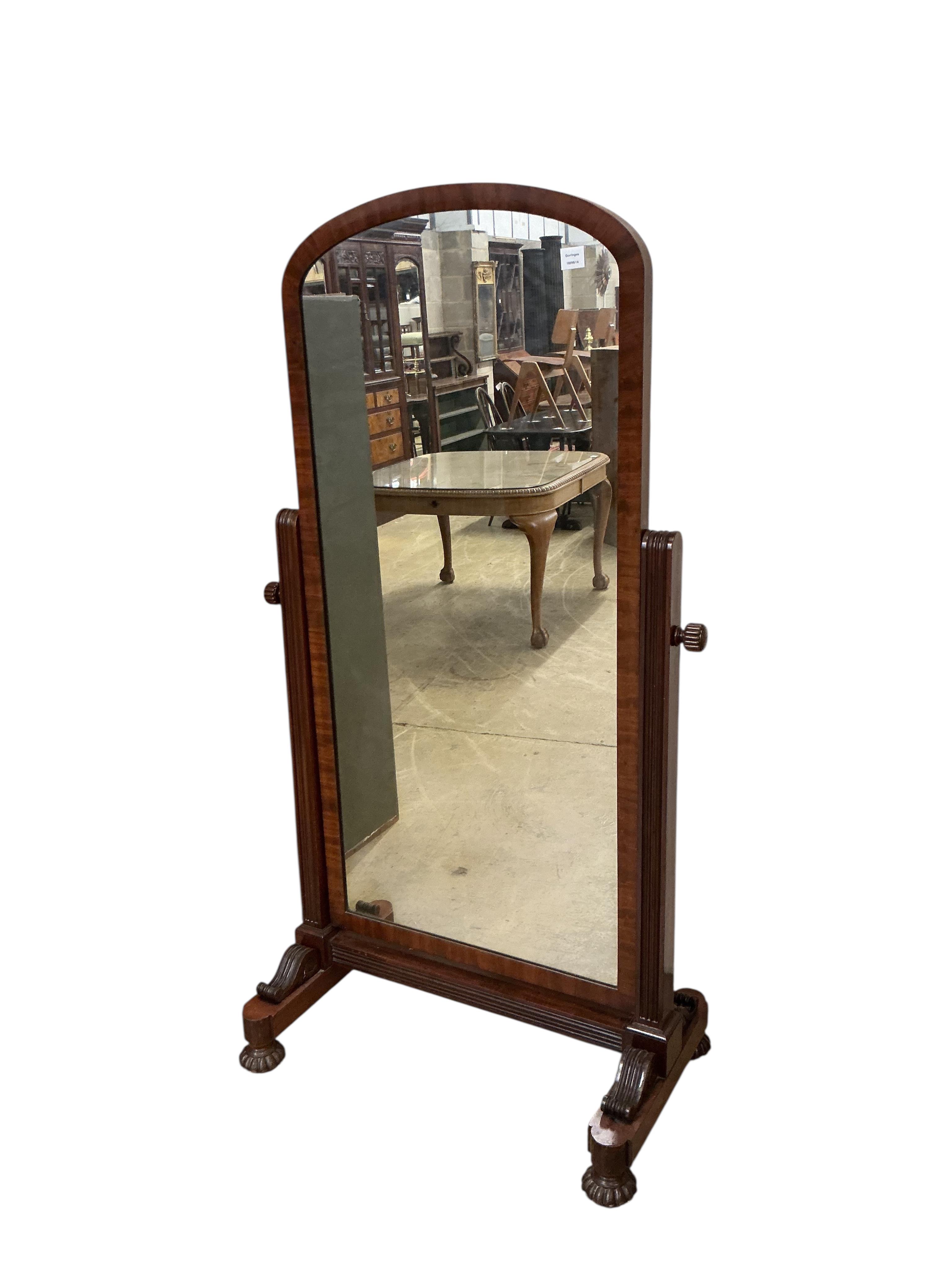 A Victorian mahogany cheval mirror, with arched plated and fluted bun feet, width 92cm, height 170cm